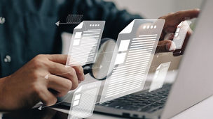 Man inspects paper with magnifying lens. Business analysis, auditing, professional document review, inquiry, and inspection are all concepts that are used in business analysis.