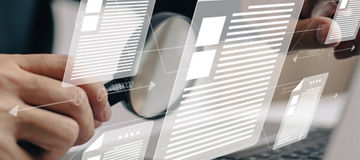 Man inspects paper with magnifying lens. Business analysis, auditing, professional document review, inquiry, and inspection are all concepts that are used in business analysis.