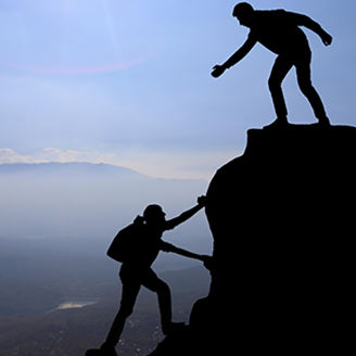 Man lending helping hand to woman hiker