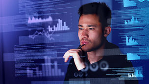 Man looking at graphs and data
