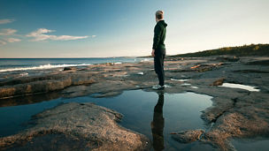 man looking at the see