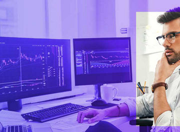 Trading online. Successful and young bearded trader in eyeglasses and formal wear working with laptop while sitting in his office in front of computer screens with trading charts