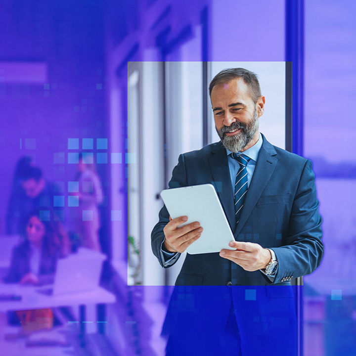 Man looking at tablet in an office