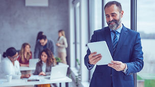 Man looking at tablet in an office