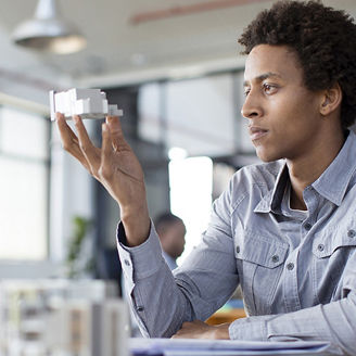 Man looking at tiny house model