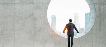 Blank space interior with view on the city and yound bussinesman wearind modern suit
