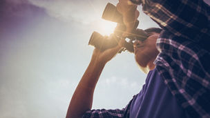 Man looking through binoculars