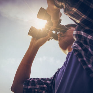 Man looking through binoculars