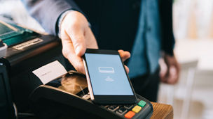 Man paying bill with phone tap