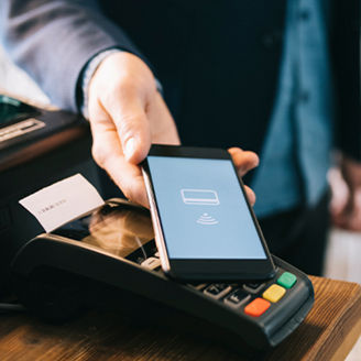 Man paying bill with phone tap