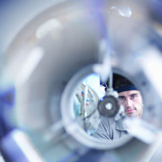 Man peeping through circular pipe