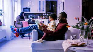 Man reading to his daughter