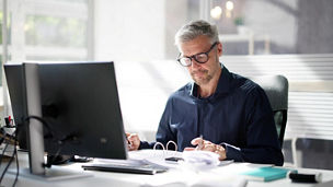 Man reviewing business document at office