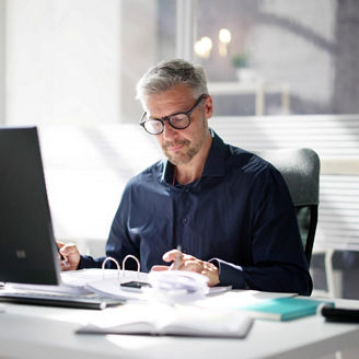 Man reviewing business document at office