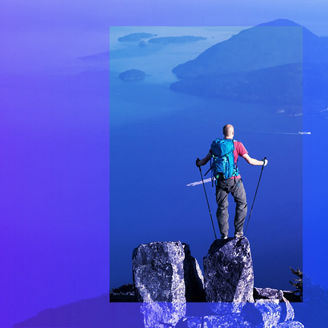 man standing on hilltop