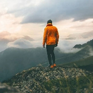 Man standing on top of mountain