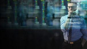 Man studying data on digital screen