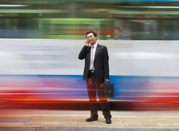 Man talking on mobile against speeding train