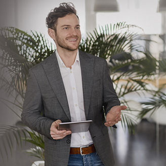 Man talking to other person with tablet in one hand