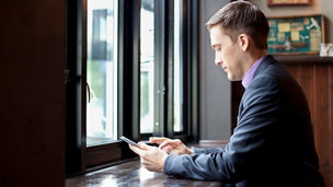 Businessman using digital tablet in cafe