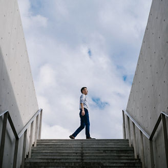 Man Walking On Top Of The Stairs