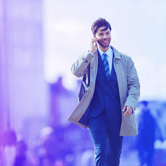 Outdoor shot of young woman using mobile phone outdoors in the city. Female business professional using smart phone in the city.