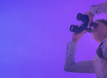 Man watching something through binoculars