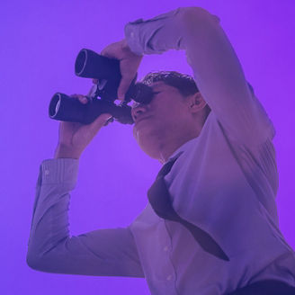 Man watching something through binoculars