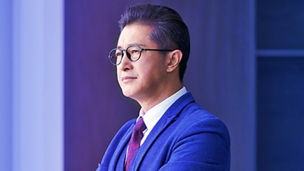 Man wearing spectacles and holding cup