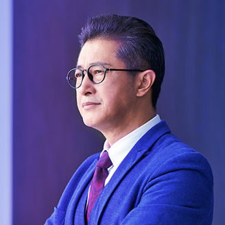 Man wearing spectacles and holding cup