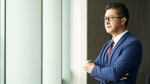 Man wearing spectacles and holding cup