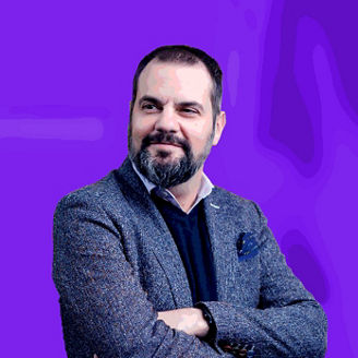 Bearded man in suit with arms crossed banner