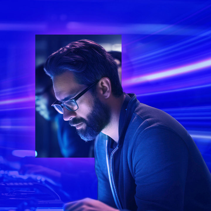 Man with glasses and technologists working on computers banner