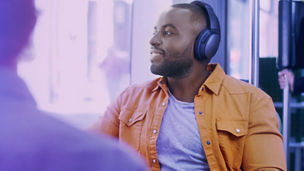 Man with headphone sitting in bus banner