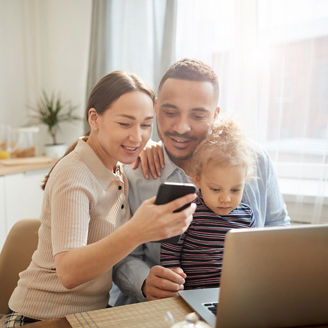 Man, woman and child sitting together at the table