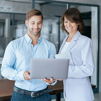 man and woman smilling with laptop