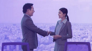 Man Women Shaking Hands in Office