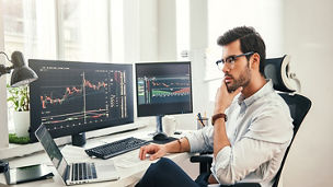 Man working on laptop and computers