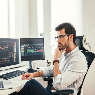 Man working on laptop and computers