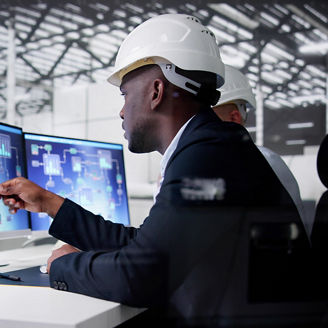 man working on two computers