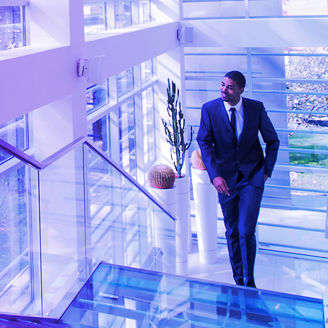 Man in a suit runs up the stairs