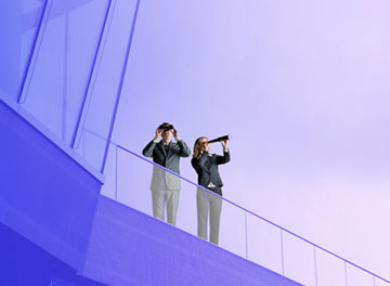 Mann und Frau auf Terasse mit Fernglas