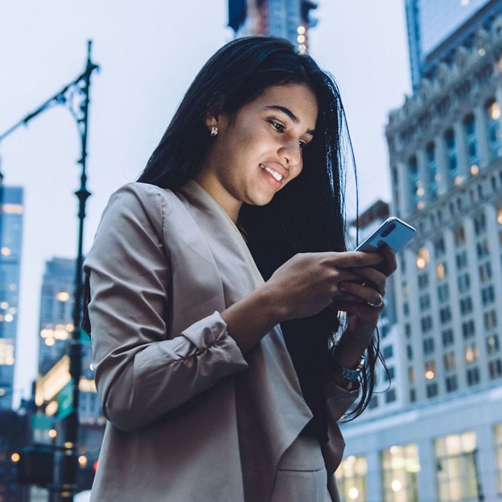 female smiling on he rphone with city view at the back