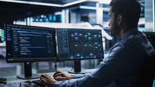 IT Specialist Administrator Working on Computer, Screen Showing Big Data AI Analysis and Code. Web Services, Machine Learning, Analytics Facility, Cyber Security. High-Tech Data Center Server Control