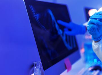 Finger on screen in white room