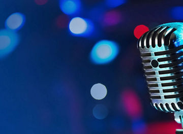 A close up shot of a microphone with a dark background