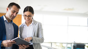 Man and woman looking at a tablet