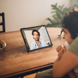 mom and son having a video call with a doctor