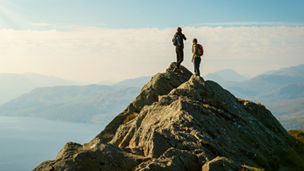 Two people shaking hands in an indoor space