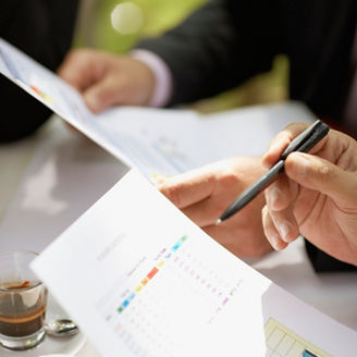 Businesspeople in a Cafe Discussing Report